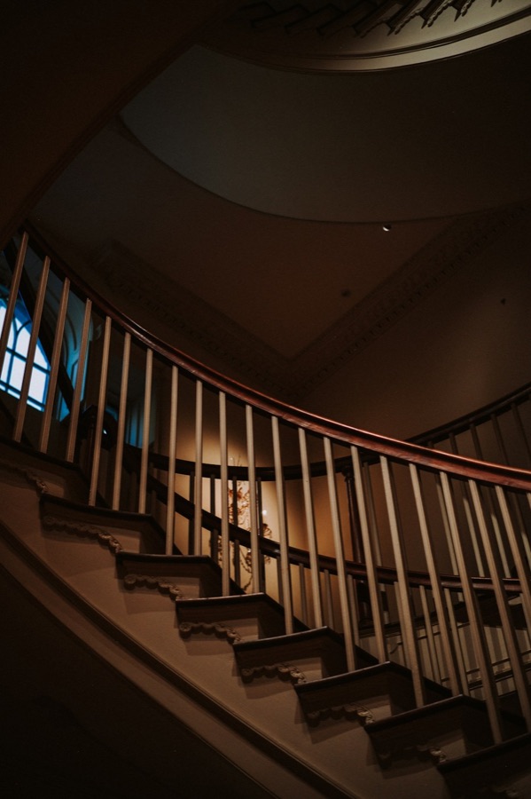 Curving staircase with a carved railing