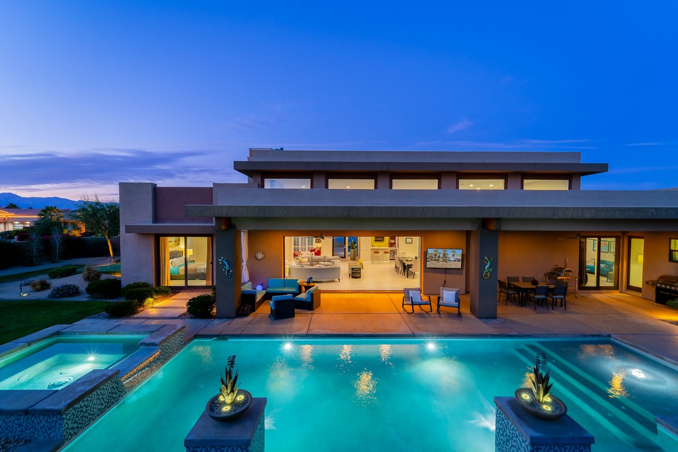 Lit pool terrace of a modern house at blue hour