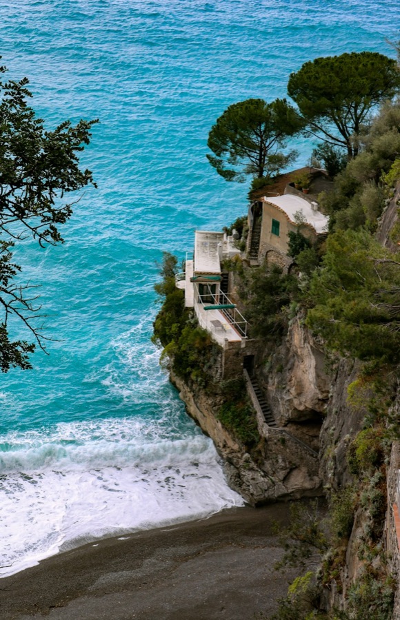 Villa on a cliff above a turquoise cove