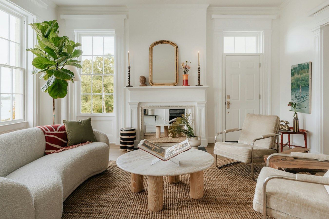 Bright living room with a fireplace and gilt mirror